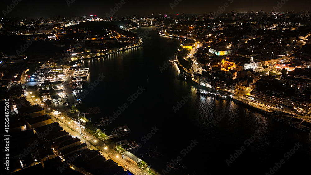 Fototapeta premium Porto at Night from Drone – Illuminated Riverside, Historic Cityscape, Douro River Lights and Old Town Architecture Captured in Stunning Aerial View. Portugal Aerial