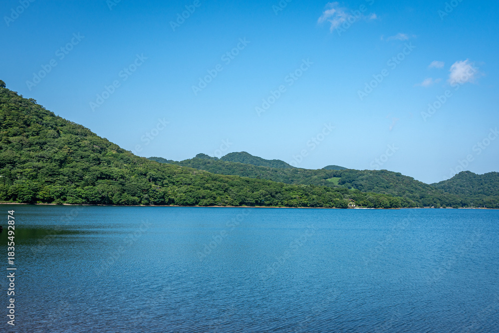 Obraz premium 群馬県大沼の青空と湖、夏の雄大な水面と山並みの風景