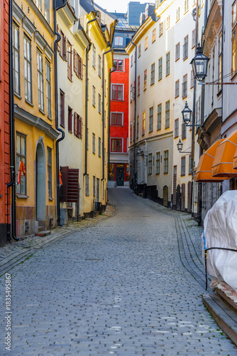 Photography Narrow cobblestone alleyway in Stockholm's Old Town with colorful buildings