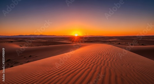 Vibrant Orange Sunset Over Rippled Desert Sand Dunes