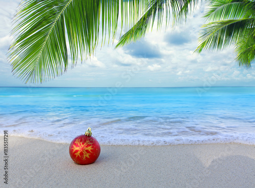 Merry Christmas background with red ball on Caribbean beach.