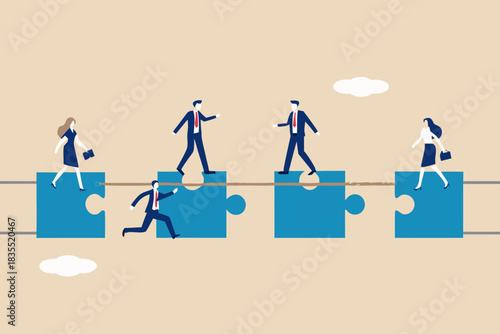 Business people crossing a rope bridge made of puzzle pieces teamwork concept