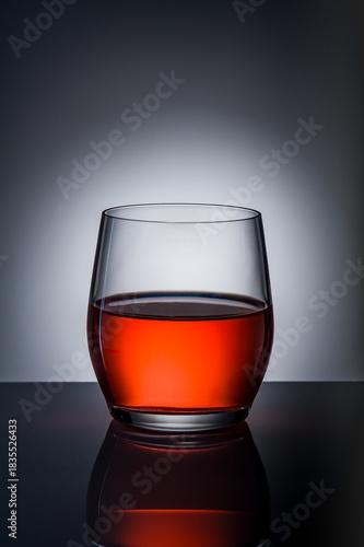 Festive Red Drink in Glass on Dark Background. Holiday Celebration Mood. Christmas Snow Globe Cocktail Concept.