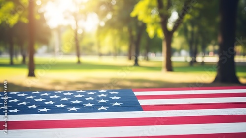 Fototapeta Naklejka Na Ścianę i Meble -  American flag displayed in a park on a sunny day