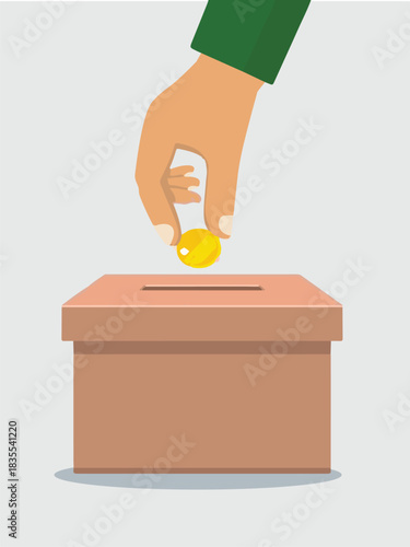 Hand dropping a gold coin into a brown cardboard donation box, illustrating charity or giving.