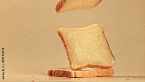 Pieces of bread fall on the table. Filmed on a high-speed camera at 1000 fps. High quality FullHD footage