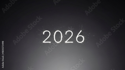 The year 2026 is illuminated with bright white sparklers against a dark moody and subtly lit background creating a festive and celebratory atmosphere