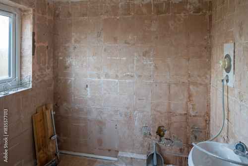 Bathroom refurbishment with stripped tiled walls