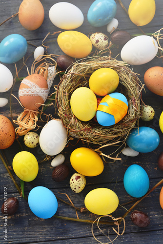 blue yellow Colored Easter eggs in eggs nest background, poster, banner, layout space for text, advertising, web, social media. Happy Easter card flyer, template card frame typography design