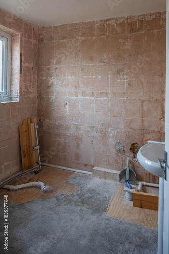 Bathroom refurbishment with stripped tiled walls