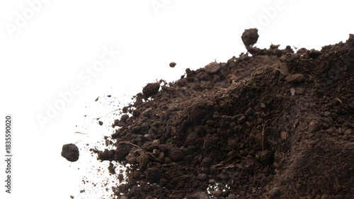 A pile of dark brown soil with small rocks and organic matter