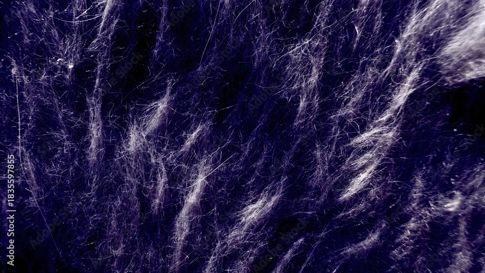 Fototapeta premium close up of tangled white fibrous strands on dark purple background with wispy blurred texture
