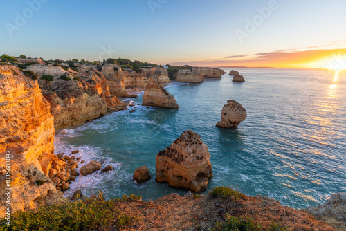 Marinha Beach, Sea Stacks, Cliffs and Atlantic Ocean at Sunrise. Algarve, Portugal. Golden Hour