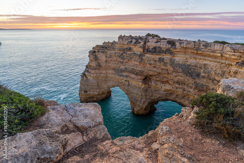 Famous Heart of the Algarve Rock Formation near Marinha Beach. Cliffs and Atlantic Ocean at Morning Twilight. Algarve, Portugal