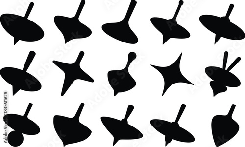 Collection of black spinning top silhouettes on white background