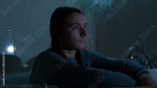 A young woman sits under running shower water, overwhelmed and exhausted. A cinematic scene symbolizing emotional breakdown, anxiety, inner struggle, and mental health crisis. 