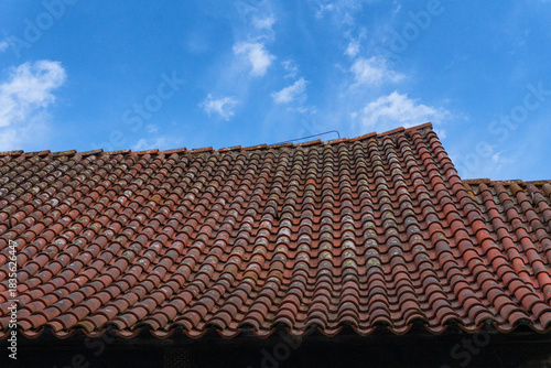 Photos Weathered beauty: close-up of aged terracotta roof tiles on a sagging gable