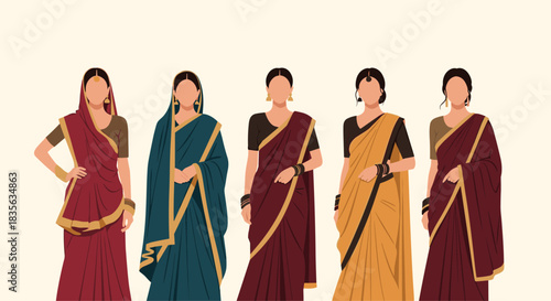 Group of five Indian women standing together, dressed in beautiful and colorful traditional sari outfits with elegant jewelry.