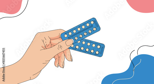 Woman's hand holding two blister packs of oral contraceptive pills for birth control and family planning on an abstract background.
