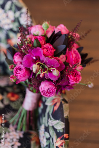 Beautiful modern bridal bouquet of colorful fresh flowers with silk ribbons. Classic wedding traditional accessory. Bride's  morning details.