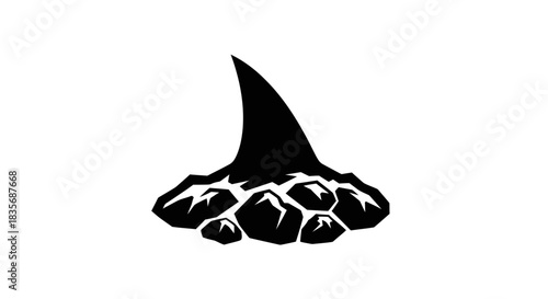 Black silhouette of a shark fin emerging from rocky water.