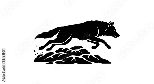 Silhouette of a Wolf Leaping Over Rocks in Striking Black and White.
