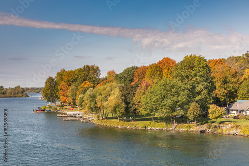 Trees of Orange, Yellow and Green Autumn Hues Along the Shore of the St. Lawrence River in Quebec, Canada