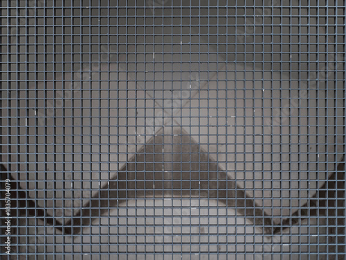 Close-up of metal wire mesh grid creating repetitive rectangular pattern with geometric perspective.