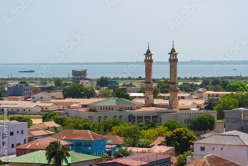 Banjul, Gambia. Elevated view of the city showing a large mosque, residential rooftops, and the distant river estuary