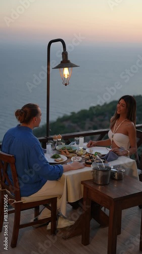 A couple enjoying a romantic dinner together in a warm and intimate atmosphere, capturing love, connection, and elegant holiday dining moments.