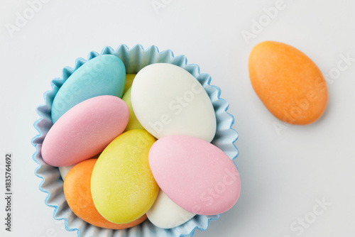 Traditional Easter Portuguese candies. Colorful Sweets in a blue paper cup on a white background