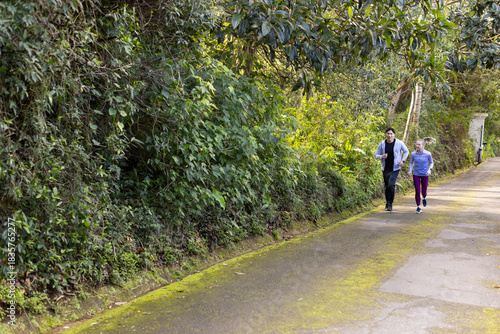 Wallpaper Mural Diverse friends wearing sportswear running together on paved pathway on forest trail, copy space Torontodigital.ca