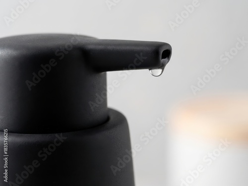 Close up of a silver metal tool, a security spray gun, isolated on a white background