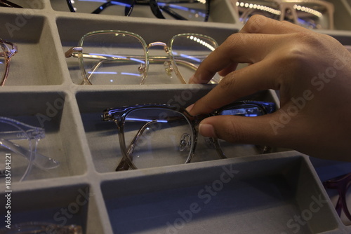 Closeup of a hand holding eyeglass 