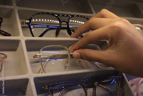 close up of a hand holding glasses 