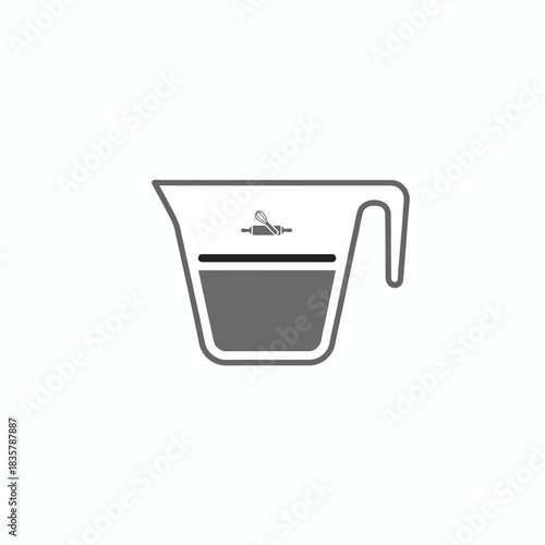 A measuring cup with baking utensils and liquid inside isolated on a white background