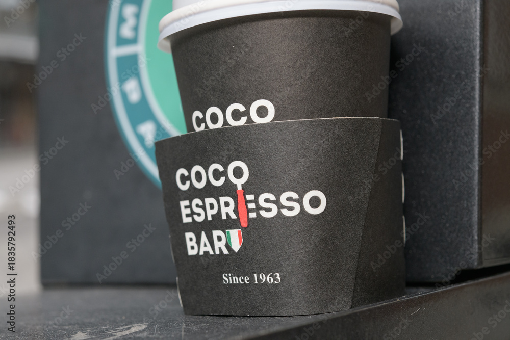 Fototapeta premium discarded beverage cup with branding of Coco Espresso Bar located at 29 Bellair St, Yorkville, Toronto
