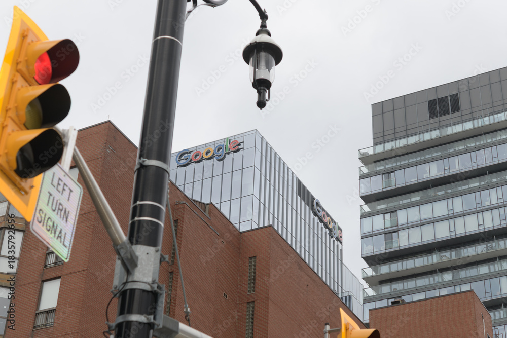 Fototapeta premium skyward view of Google signs at top of Google King East, corporate office, 65 King St E, Toronto