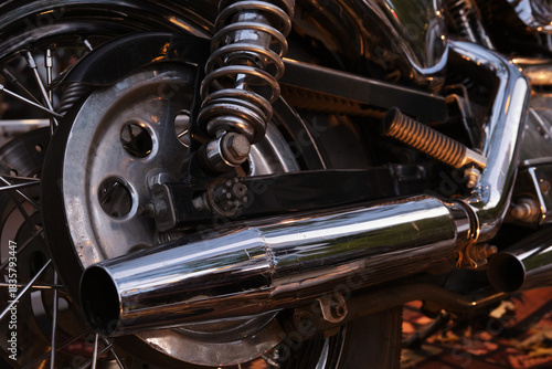 Close-up of the exhaust pipe of a vintage motorcycle.