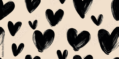 Bold monochrome seamless pattern of oversized brush-painted black hearts on a textured light beige background for modern graphic design.