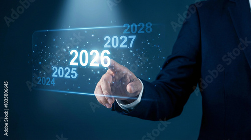 Businessman touching 2026 on a futuristic screen, forecasting the future with digital technology, strategic planning for the next year, success and innovation