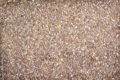 Gravel stone on brown wall background