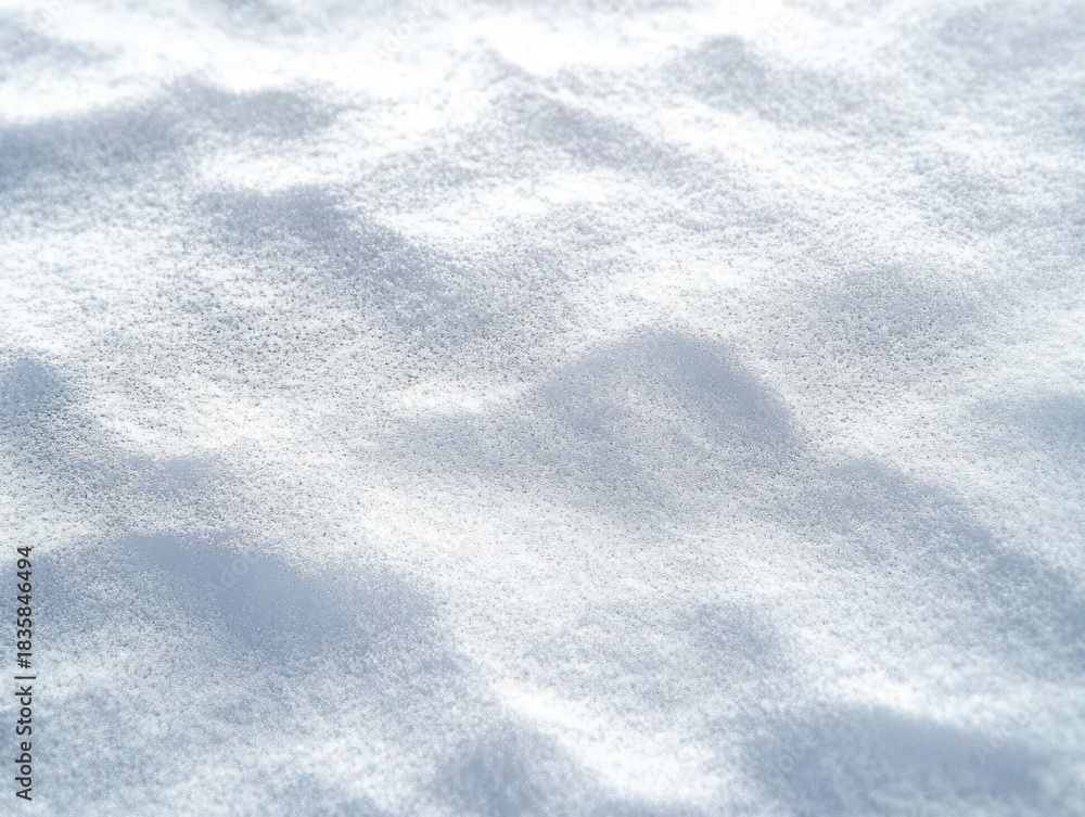 Obraz premium Close-up view of soft, freshly fallen snow with small mounds and a smooth, powdery texture under diffused light