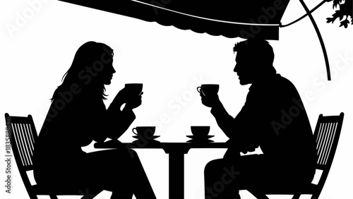 Silhouette of a couple enjoying coffee at an outdoor cafe.