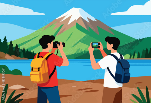 Two figures take photos of a snow-capped mountain overlooking a lake, with green slopes, blue sky, and foliage