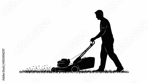 Silhouette of a man mowing a lawn with a push mower.