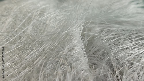 Close up fiberglass stack on a gray background. Fiberglass is a resin reinforced glass fiber composite that is lightweight and strong, corrosion resistant, and a good thermal insulator.