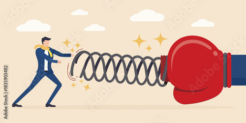 Businessman pushing back against a powerful boxing glove with a spring