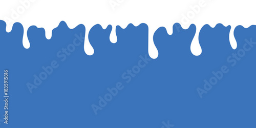 drops of milk falling down on a blue background
