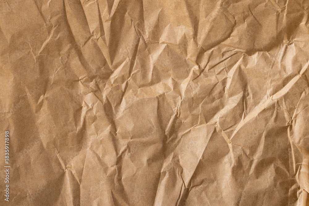 Obraz premium Crumpled brown paper texture,Close-up view of crumpled brown paper. Abstract pattern of crumpled brown paper. Crumpled brown paper texture background